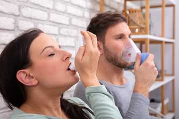 Couple Using Asthma Inhaler