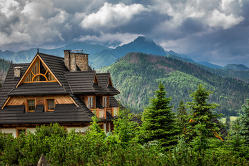 Wooden cottage and clouds over Tatra Mountains, Poland