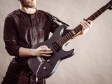 Young man playing electric guitar