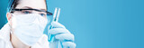chemist holding a test tube on blue background