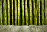 Empty wooden table and bamboo sticks