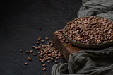 Roasted coffee beans on a dark background. Photo with negative space.