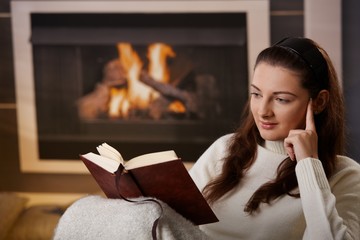 Woman sitting at fireplace