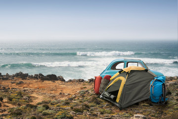 Tourist camp with tent and car on the ocean