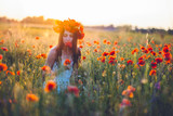 Woman at a flower field in summer sunset
