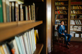 Groom photographed in his private library. Luxury Wedding