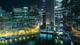 Beautiful time lapse of the many high-rise buildings along the Chicago River at night.