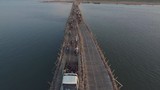 aerial drone shot : low fly over traffic jam on the bamboo bridge over the Mekong River at the end of the day