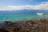 Paradise Turquoise Adriatic Sea with white boat. Krk Island, Croatia.