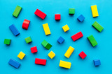 Children background. Wooden building blocks for developing and entertainment on blue background top view
