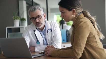 Doctor having medical appointment with patient in hospital