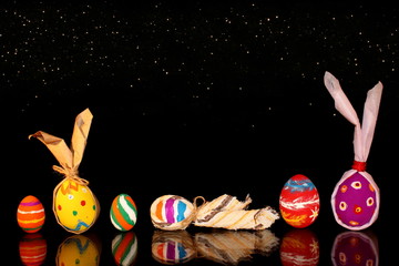 beautiful colorful, painted Easter eggs on a shiny background