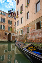 Gondola in narrow canal in Venice, Italy