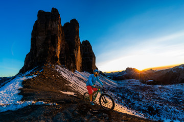 Cycling  man riding on bike in Dolomites mountains landscape. Couple cycling MTB enduro trail track. Outdoor sport activity.