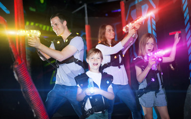Kids and adults in beams on lasertag arena