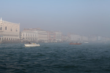 Quay of San Marco and the lagoon in the fog of Venice