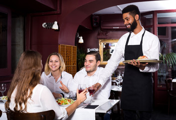 Middle class restaurant and cheerful waiter