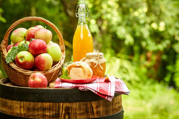 apples on background orchard standing on a barrel. Apple juice and apple preserves.