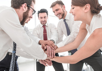 happy colleagues connects their hands together