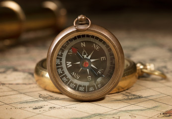 antique compass on map