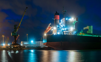 bulk cargo ships in the harbor at night