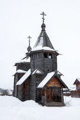 Front view of a wooden church in snow