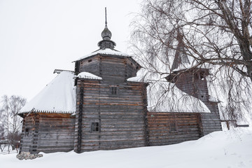 Side view of a wooden church in the snow