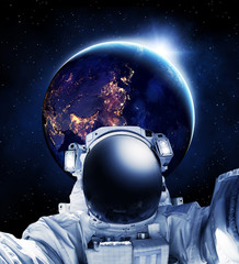 Astronaut in outer space, earth in the background - Some elements of this image furnished by NASA
