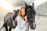 girl with a horse on the racetrack