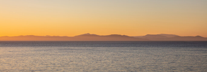 Aegean sea and Attica Greece hills, view from Kea island at sunset time, clear sky background, banner
