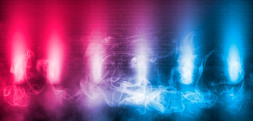 Empty scene background. Empty brick wall, concrete floor, spotlight, multicolored neon rays, bokeh.