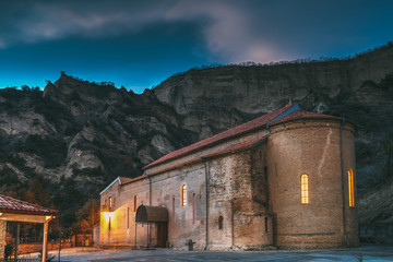 Mtskheta, Georgia. Shio-Mgvime Monastery. Upper Church Of Holy Virgin Or Theotokos, Central Part Of Medieval Monastic ShioMgvime Complex In Limestone Canyon In Autumn Sunset. Colorful Sky Above Famous
