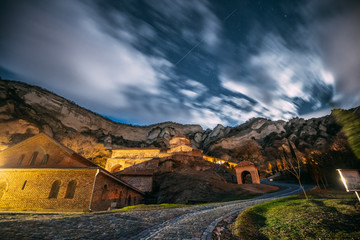Mtskheta, Georgia. Medieval Monastic Shio-Mgvime Monastery Shiomgvime Complex Under Autumn Night Starry Sky With Glowing Stars And Real Meteoric Track Trail Over Above Famous Place.