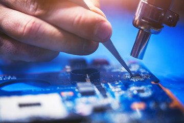 Man installing microchip on the main board