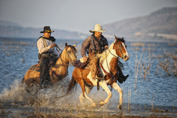 cowboy and horse  at first light,mountain, river and lifestyle with natural light background