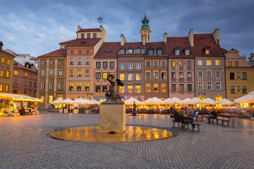 Statue of mermaid in Warsaw old town at dusk, Poland