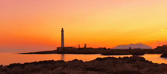 beautiful romantic colorful Sunset on Favignana’s lighthouse - Punta sottile, Favignana - Sicily Italy