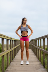 Summer fitness lifestyle motivation. Young sporty woman taking an outdoor running workout rest.
