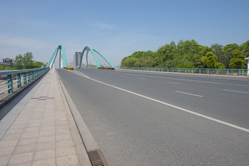  Asphalt highway under the urban steel frame bridge