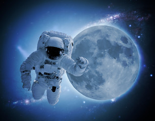 astronaut levitate in space in front of moon. elements of this images furnished by nasa