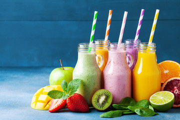 Summer colorful fruit smoothies in jars with ingredients. Healthy, detox and diet food concept.