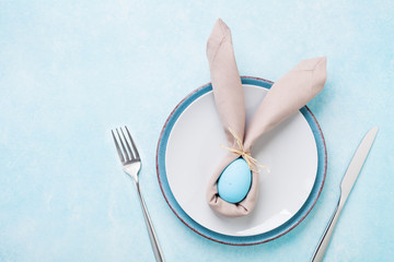 Easter table setting concept. Funny rabbit top view and flat lay.