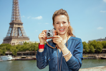 solo traveller woman taking photos with retro photo camera