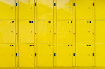Stack of yellow lockers door at public locker service