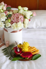 flowers and fruit in bed, hotel room