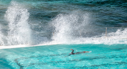 Swimmer enjoys beautiful pool along the ocean