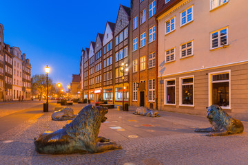 Architecture of the old town of Gdansk with bronze lions statues - emblem of the city, Poland