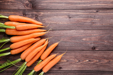 Fresh and sweet carrot on wooden background