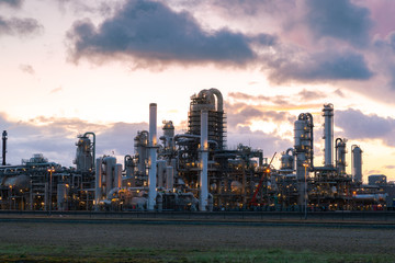 Oil and gas refinery plant or petrochemical industry on sky sunset background, Gas storage sphere tank and distillation tower in petroleum industrial