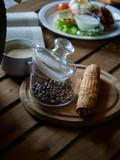 Glass jar and beans of natural coffee.